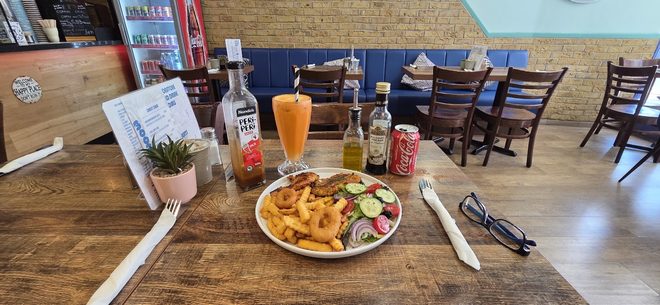 Chips and salad on a cafe table looking out across the blue-walled dining room